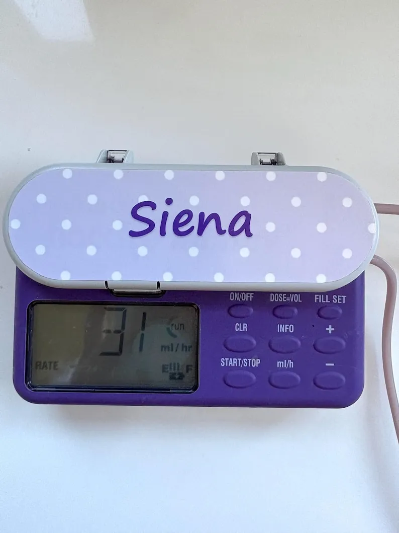 A feeding pump with a purple polka dot sticker reading the name Siena.