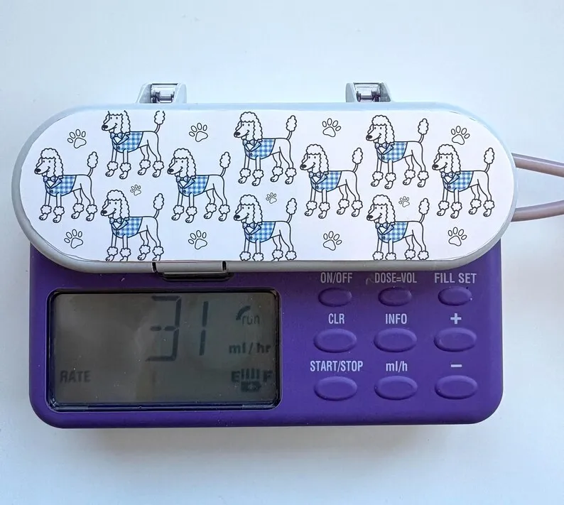 Poodles sticker on a feeding tube pump